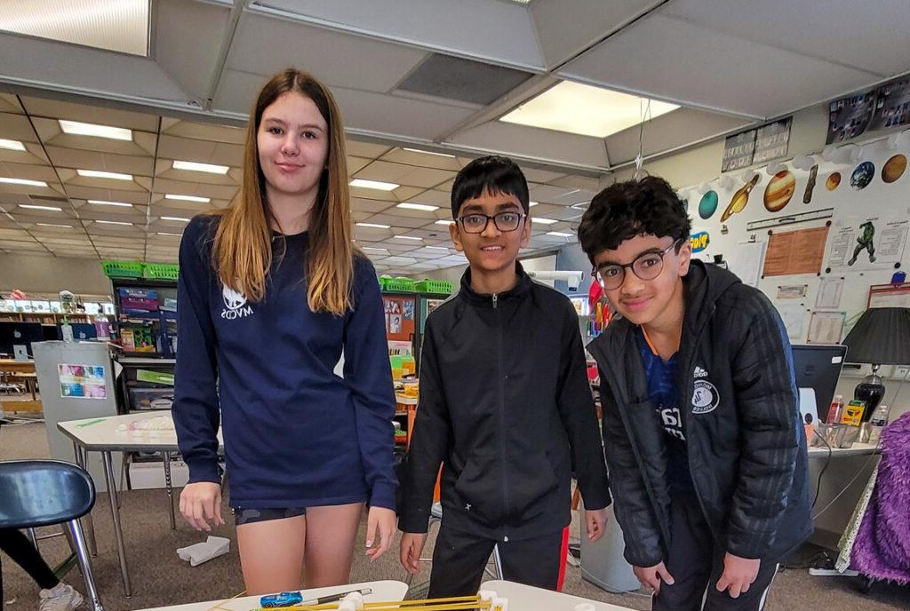 3 students smiling in classroom